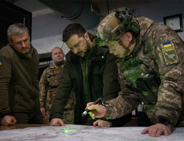 a group of men looking at a map