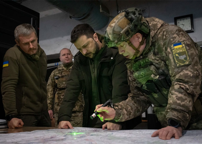 a group of men looking at a map