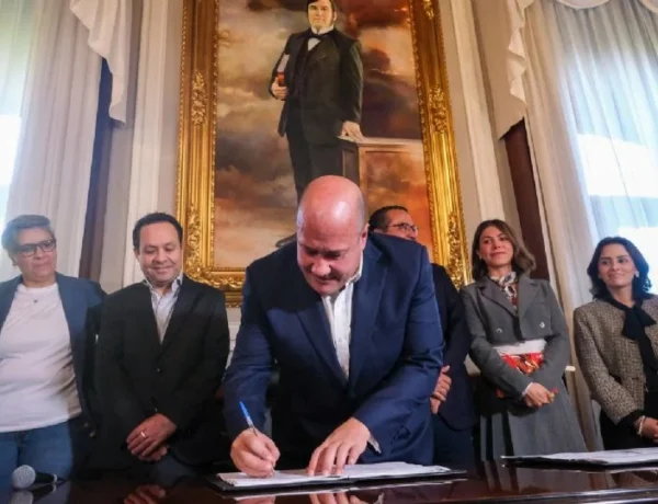 a man in a suit signing a document