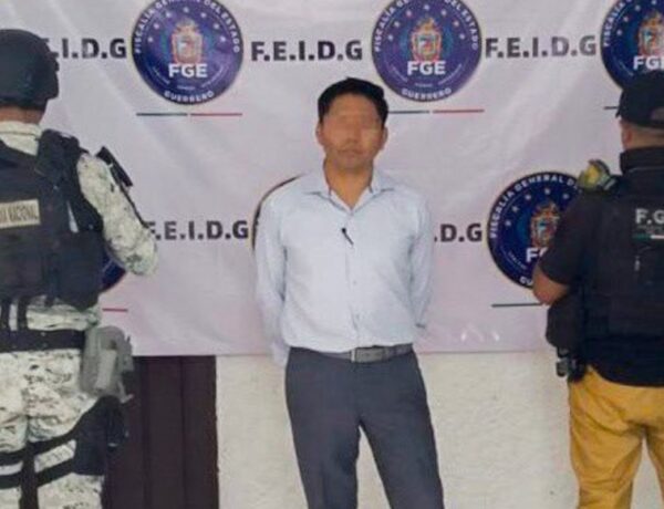 a man standing in front of a banner with police officers