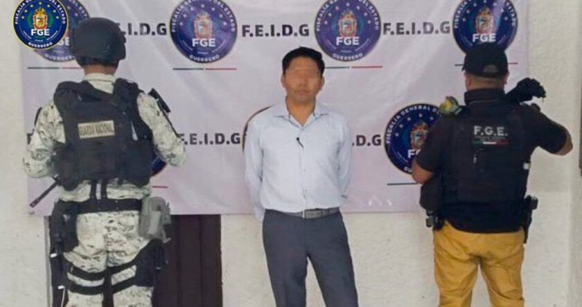 a man standing in front of a banner with police officers