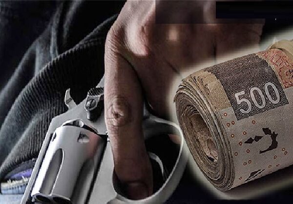 a hand holding a gun and a roll of money