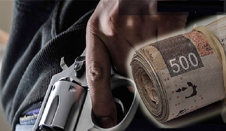 a hand holding a gun and a roll of money